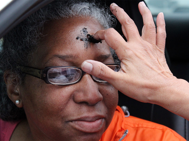 Jacqui Hunter of Silver Spring, Md., stopped at the parking lot of Glenmont United Methodist Church in Silver Spring, Md., to receive ashes on Ash Wednesday on March 1, 2017. RNS photo by Adelle M. Banks