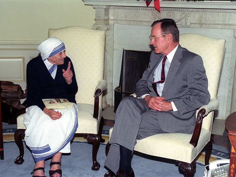 Mother Teresa of Calcutta gestures as she talks to President George Bush as the two meet on Dec. 9, 1991, in the Oval office at the White House. Photo courtesy of Reuters/ Rick Wilking