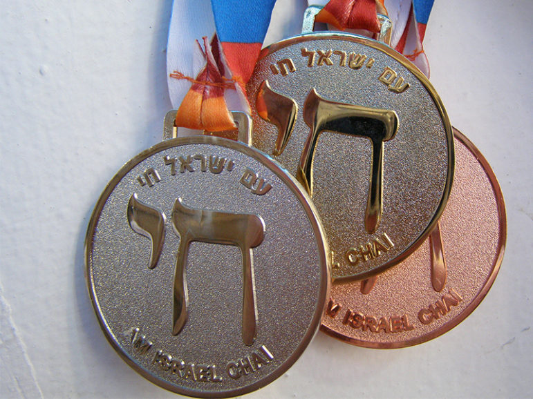 Medals at the 2009 Maccabiah games feature the Hebrew chai symbol, with slogan 