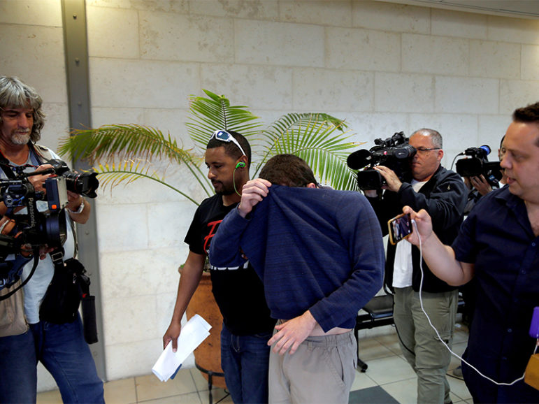 A U.S.-Israeli teen who was arrested in Israel on suspicion of making bomb threats against Jewish community centers in the United States, Australia and New Zealand over the past three months is seen before the start of a remand hearing at Magistrate's Court in Rishon Lezion, Israel, on March 23, 2017. Photo courtesy of Reuters/Baz Ratner