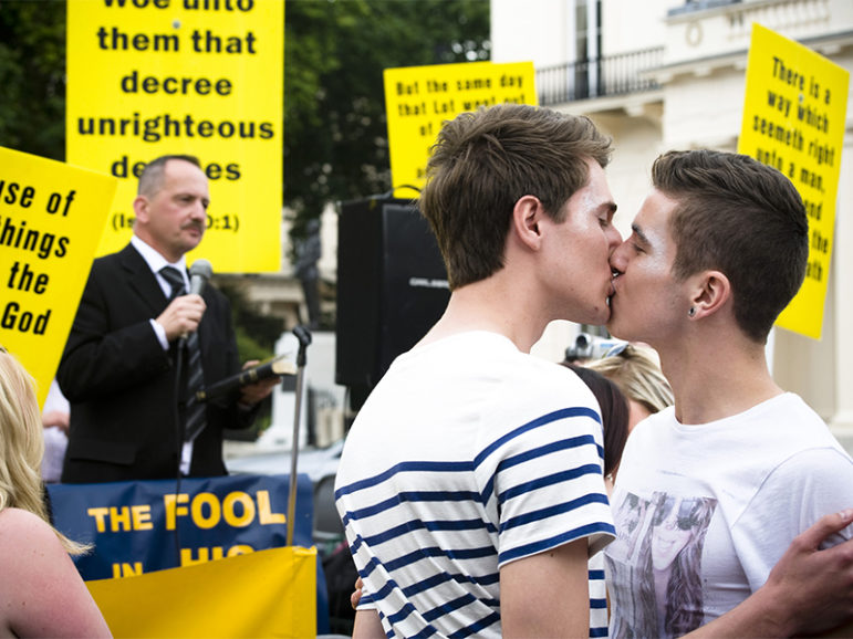 Two men kiss in front of a group of evangelicals protesting the 2011 London Pride. 