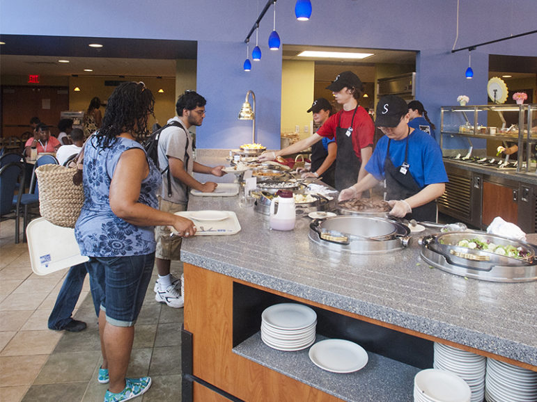 Penn State Housing and Food Services staff serve lunch to students on August 1, 2011, at the all you can eat 'South Side Buffet' in Redifer Commons on the University Park campus. Photo courtesy of Creative Commons/Penn State/Patrick Mansell