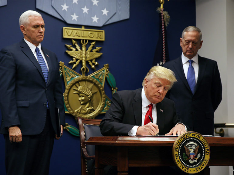 U.S. President Donald Trump signed a revised executive order for a U.S. travel ban, leaving Iraq off the list of targeted countries, on March 6, 2017.  Trump signs the original ban at the Pentagon in Washington, D.C., on Jan. 27, 2017. Photo courtesy of Reuters/Carlos Barria