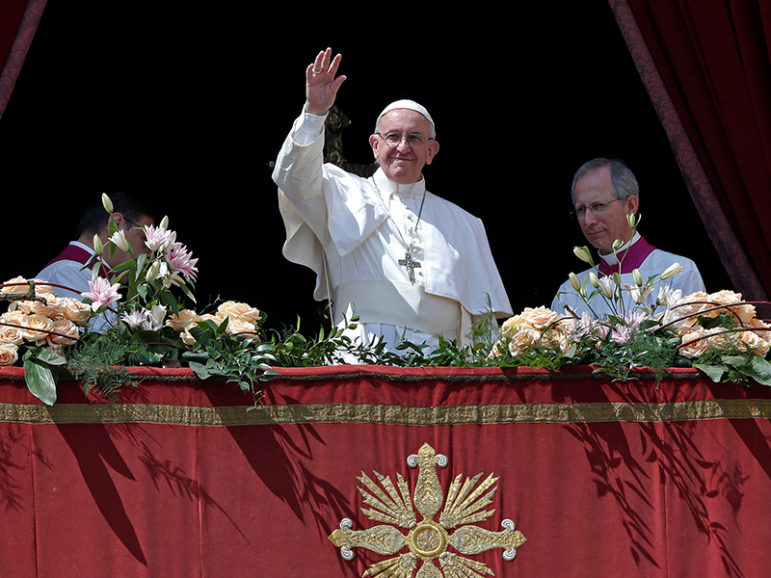 Pope Francis waves at the end of his 