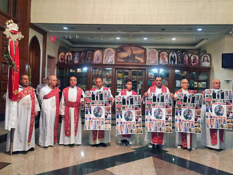 Coptic clergy hold signs to remember victims of the  Palm Sunday attack in Egypt during a service at the Church of Virgin Mary and St. Athanasius on April 18, 2017, in Mississauga, Ontario, near Toronto.  Photo courtesy of Hira Hyder