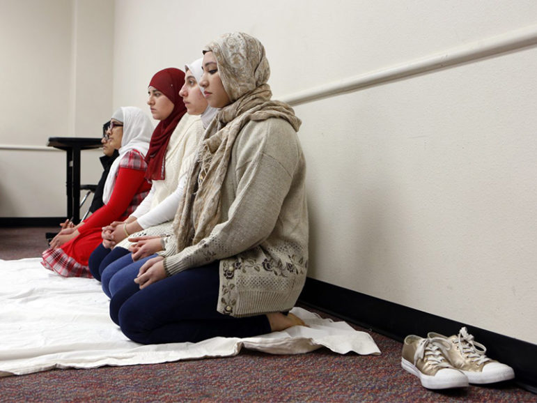 Amna Salman, foreground, and other Muslim students gather to pray inside a classroom at Liberty High in Frisco. Photo courtesy of Lara Solt/KERA News