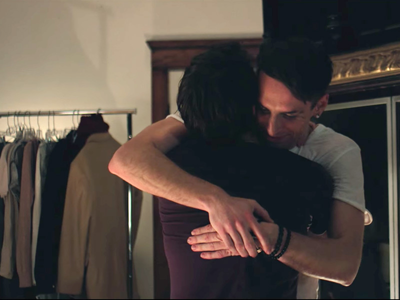 Artist Trey Pearson hugs a man in a final scene from the music video of his new single, “Silver Horizon.” Screenshot from YouTube