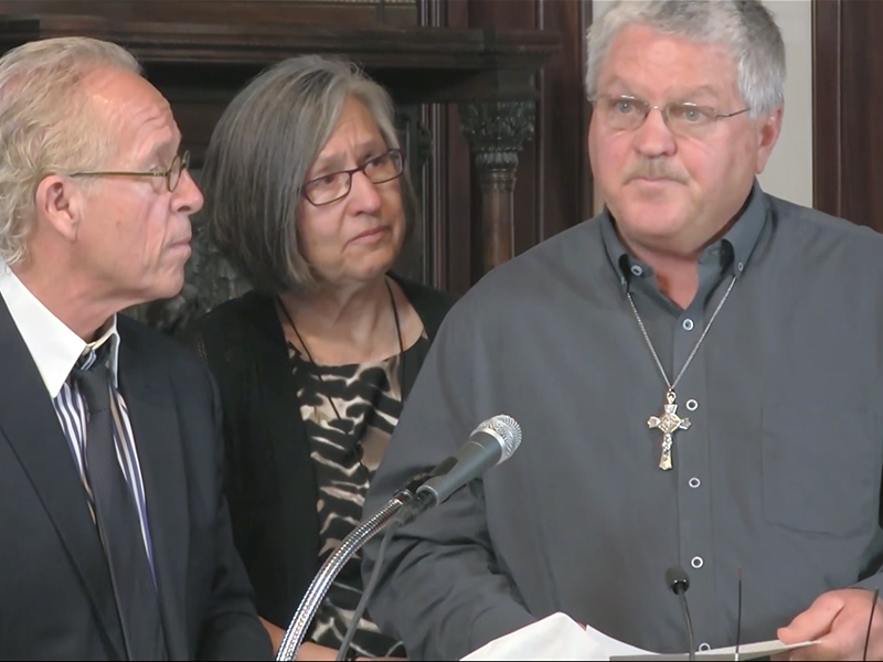 Ronald Vasek, right, with his wife and attorney, explains his coercion suit against Bishop Michael Joseph Hoeppner during a news conference on May 9, 2017, in Crookston, Minn.  Screenshot from YouTube