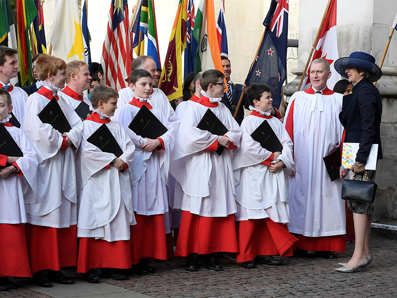 Britain's Prime Minister Theresa May, right, talks with choristers after a Commonwealth Day service at Westminster Abbey in London on March 13, 2017. Photo courtesy of Reuters/Toby Melville