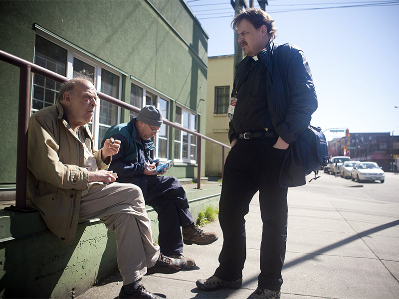 The Rev. Matthew Johnson talks with men in downtown Vancouver, British Columbia. Johnson runs the Street Outreach Initiative at St. James' Anglican Church on Vancouver’s downtown east side.  Photo courtesy of Chris Loh