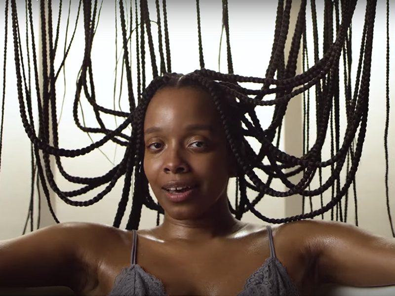 Artist Jamila Woods in her new music video “Holy.” Screenshot from YouTube