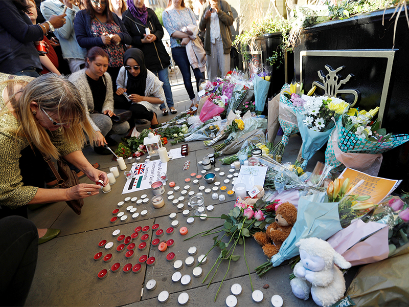 People take part in a vigil for the victims of an attack on concert goers at Manchester Arena, in central Manchester, Britain, on May 23, 2017. Photo courtesy of Reuters/Peter Nicholls