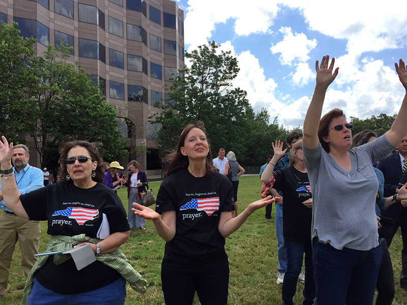 Lisa Hall, center, of Holly Springs, N.C. prays at the National Day of Prayer gathering in Raleigh, N.C., on May 4, 2017. RNS photo by Yonat Shimron