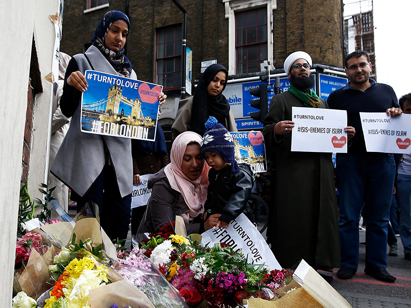 Muslims pray at a floral tribute near London Bridge, after attackers rammed a hired van into pedestrians on London Bridge and stabbed others nearby killing and injuring people, in London on June 3, 2017. Photo courtesy of Reuters/Peter Nicholls