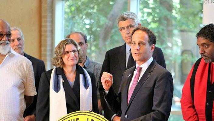 Rabbi Jonah Pesner, director of Reform Judaism's Religious Action Center, gestures while speaking. Also featured: Rabbi Lucy Dinner of Raleigh, N.C.; Rabbi Rick Jacobs, president of the URJ; and the Rev. William Barber, president of the North Carolina NAACP.