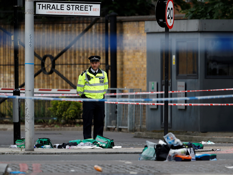 A police officer stands behind discarded medical equipment near Borough Market after an attack left 7 people dead and dozens injured in London, Britain, on June 4, 2017. Photo courtesy Reuters/Peter Nicholls  