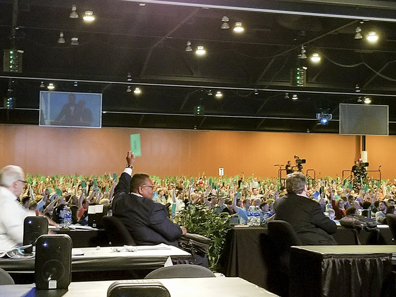 Messengers raise their ballots to approve a request by the Resolutions Committee to present a resolution on 
