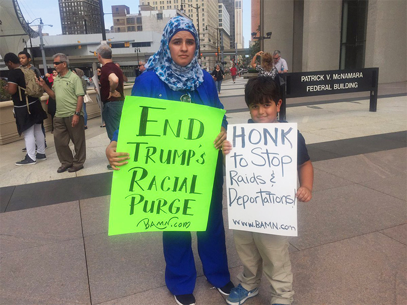 Doaa Aldilaimi and her 6-year old son Mohammed protest the recent ICE arrests in the Detroit area.  Photo courtesy of Detroit Free Press/Allie Gross