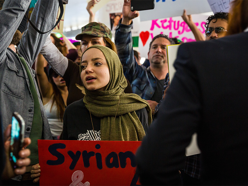 A young woman protests the Muslim travel ban at Los Angeles International Airport on Jan. 29, 2017. Photo courtesy of Dustin Pearlman