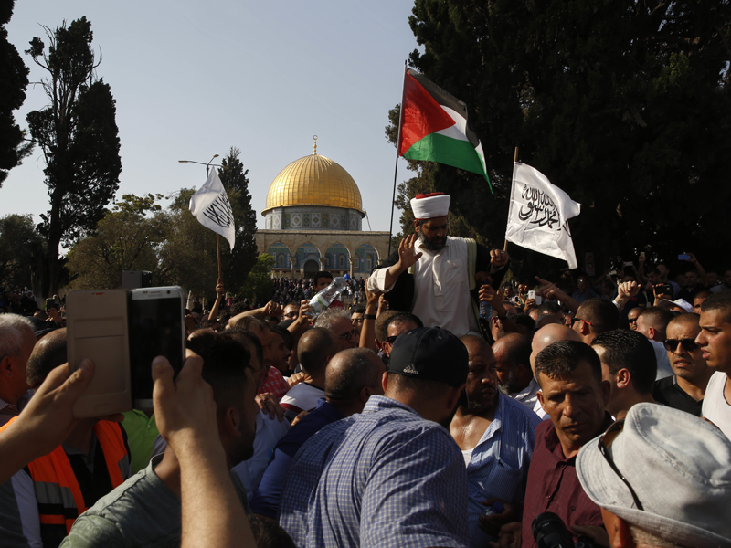 Palestinians are seen inside the Al-Aqsa Mosque compound in Jerusalem's Old City on July 27, 2017. Thousands of Muslims flocked to a major Jerusalem shrine Thursday for the first organized prayers at the site in nearly two weeks, following Israel's removal of security devices installed after a deadly attack. (AP Photo/Mahmoud Illean)