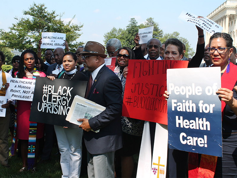 An ecumenical group of African-American clergy gather outside the U.S. Capitol in opposition to the proposed pending budget and health care bill on July 18, 2017.  RNS photo by Madeleine Buckley