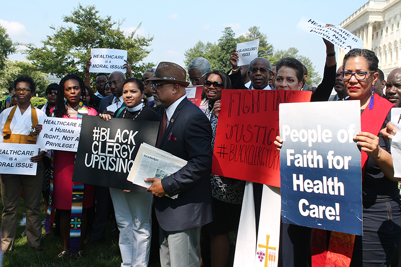 An ecumenical group of African-American clergy gathers outside the U.S. Capitol in Washington, D.C., on July 18, 2017, in opposition to the proposed budget and the health care bill. RNS photo by Madeleine Buckley