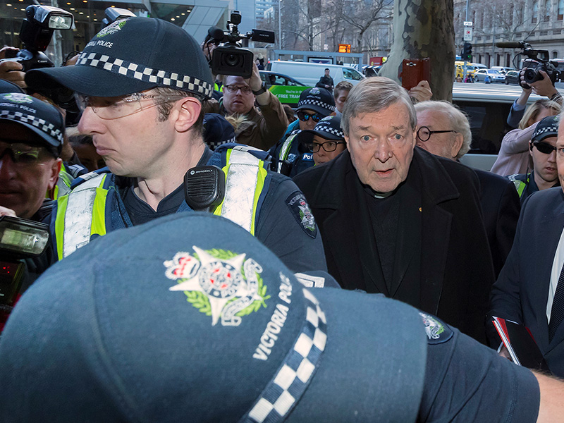 Vatican Treasurer Cardinal George Pell is surrounded by Australian police and members of the media as he arrives at the Melbourne Magistrates Court in Australia on July 26, 2017. Photo  by Mark Dadswell/Reuters