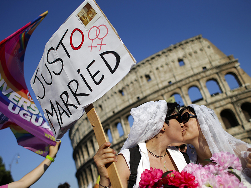 A lesbian couple kiss in front of the Colosseum during the annual gay pride parade in downtown Rome on June 15, 2013. Photo by Max Rossi/Reuters