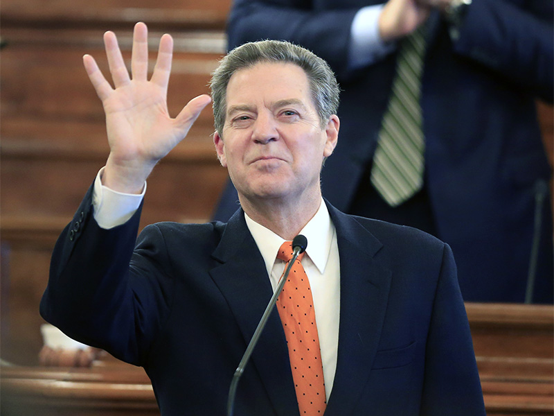 Kansas Gov. Sam Brownback waves to guests before delivering his State of the State address to a joint session of the Kansas Legislature in Topeka on Jan. 10, 2017. (AP Photo/Orlin Wagner)