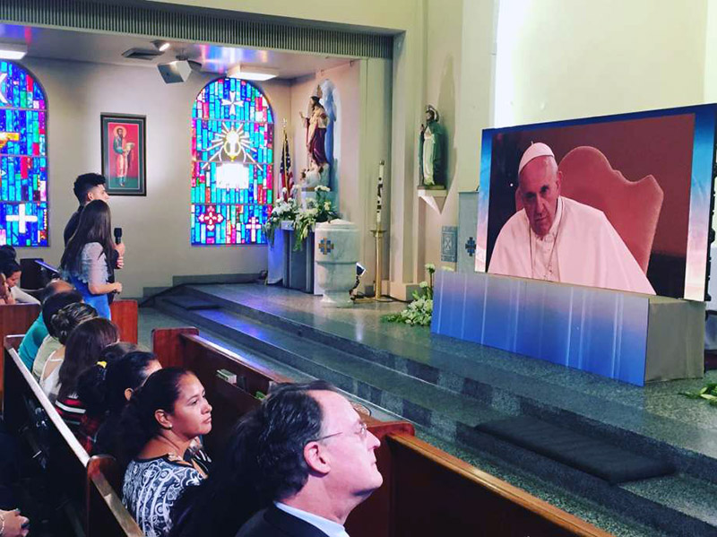 Ricardo Ortiz, a Roman Catholic parishioner in Houston, talks with Pope Francis during an Aug. 31, 2015, satellite live-link audience in a McAllen, Texas, church. With Texas' immigration enforcement law taking effect Sept. 1, Ortiz, now 21, worries about his parents, who are in the U.S. illegally. Photo courtesy of Ricardo Ortiz
