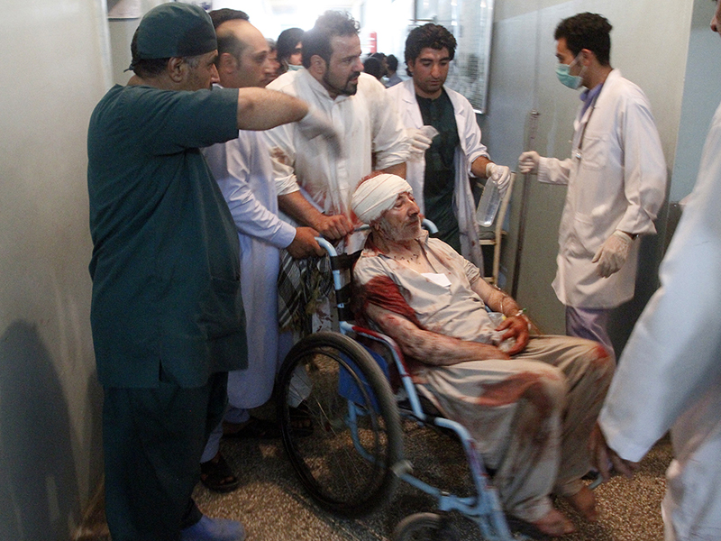 Relatives assist a wounded man in a hospital after a suicide attack on a mosque in Herat, Afghanistan, on Aug. 1, 2017. (AP Photo/Hamed Sarfarazi)