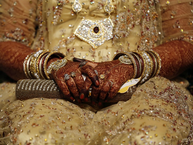 In this May 11, 2014, file photo, an Indian Muslim bride sits during a mass marriage where 35 couples got married in Mumbai, India. India's Supreme Court said Aug. 22, 2017, that the Muslim practice that allows men to instantly divorce their wives is unconstitutional and requested the government legislate an end to the practice. (AP Photo/Rajanish Kakade, File)