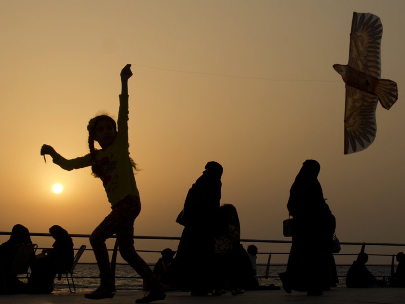 In this April 8, 2017, file photo, a girl plays with her kite as visitors walk on the Red Sea beach in Jiddah, Saudi Arabia. Saudi Arabia is planning to build a semi-autonomous luxury travel destination along its Red Sea coast that visitors can reach without a visa. The Red Sea area, which will include diving attractions and a nature reserve, will be developed with seed capital from the country's Public Investment Fund. (AP Photo/Amr Nabil, File)