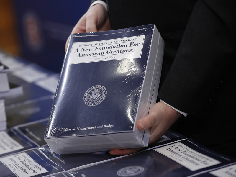 Eric Ueland, Republican staff director, Senate Budget Committee, holds a copy of President Trump's fiscal 2018 federal budget before distributing copies to congressional staffers on Capitol Hill in Washington on May 23, 2017. (AP Photo/Pablo Martinez Monsivais)
