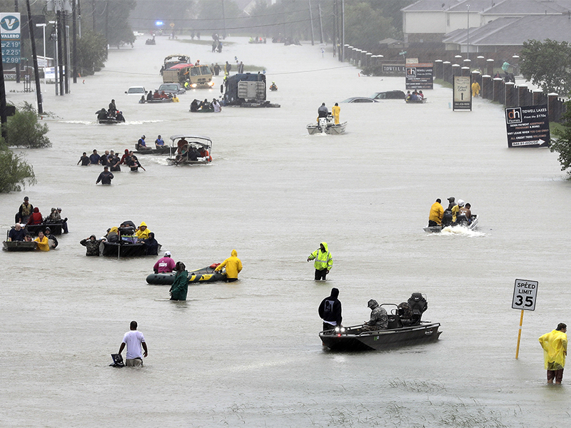 Rescue boats fill a flooded street as flood victims are evacuated as floodwaters from Tropical Storm Harvey rise on Aug. 28, 2017, in Houston. (AP Photo/David J. Phillip)