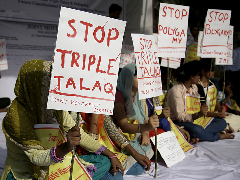 Activists of various social organisations hold placards during a protest against 