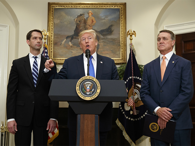 President Trump, flanked by Sen. Tom Cotton, R-Ark., left, and Sen. David Perdue, R-Ga., speaks in the Roosevelt Room of the White House in Washington, D.C., on Aug. 2, 2017, during the unveiling of legislation that would place new limits on legal immigration. (AP Photo/Evan Vucci)