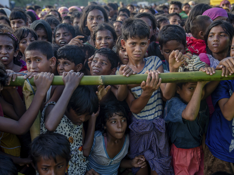 In this Monday, Sept. 25, 2017, file photo, Rohingya Muslim children, who crossed over from Myanmar into Bangladesh, wait to receive aid during a distribution near Balukhali refugee camp, Bangladesh. The prejudice and hostility that Rohingya Muslims face stretches beyond Myanmar’s notoriously brutal security forces into a general population receptive to an often virulent form of Buddhist nationalism that has seen a resurgence since the end of military rule. (AP Photo/Dar Yasin, File)