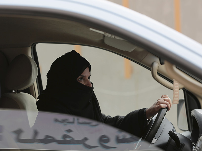 In this March 29, 2014, file photo, Aziza Yousef drives a car on a highway in Riyadh, Saudi Arabia, as part of a campaign to defy Saudi Arabia's ban on women driving. Saudi Arabia says it will allow women to drive for the first time in the ultraconservative kingdom. The kingdom, which announced the change on Sept. 26, 2017, was the only country in the world to bar women from driving and for years had garnered negative publicity internationally for detaining women who defied the ban. (AP Photo/Hasan Jamali, File)