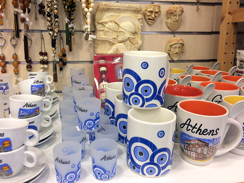 Evil-eye-themed mugs and shot glasses for sale at the Monastiraki market in Athens, Greece. RNS photo by Jenny Lower