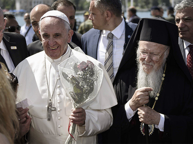 Pope Francis, left, is escorted by Ecumenical Patriarch Bartholomew I, during a visit to the Greek island of Lesbos on April 16, 2016. (Andrea Bonetti/Greek Prime Minister's Office via AP)