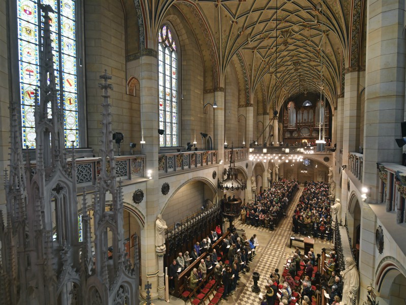 Visitors of the service sit in the All Saints' Church or Castle Church in Wittenberg, Germany, on Oct. 31, 2017. German leaders will mark the 500th anniversary of the day Martin Luther is said to have nailed his theses challenging the Catholic Church's practice of selling indulgences to a church door, a starting point of the Reformation. (Hendrik Schmidt/dpa via AP)