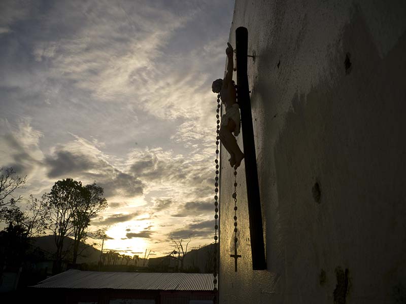 A cross hangs from a wall that remains of Luis Cosme's house, destroyed by Hurricane Maria, in the San Lorenzo neighborhood of Morovis, Puerto Rico, Sunday, Oct. 1, 2017. Luis, a worker at a cleaning company, felt the high winds and ran to the shelter at the Catholic church building. In the morning he came out and saw his house gone. 