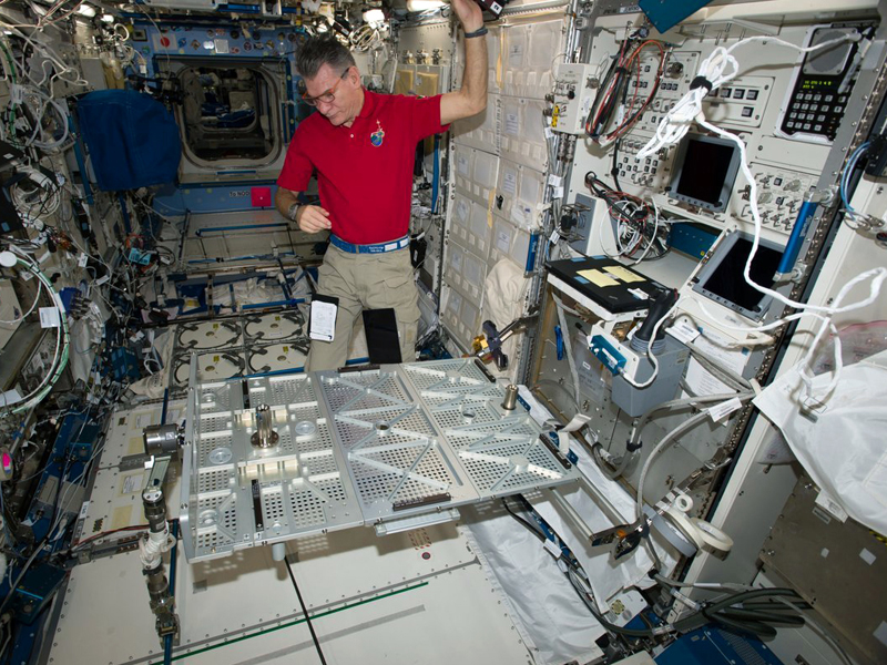 In this photo provided the European Space Agency on Wednesday, Oct. 25, 2017, Italian astronaut Paolo Nespoli looks at the Multipurpose Transporting Plate aboard the International Space Station. Pope Francis is making his first phone call off the planet - and into space. On Thursday, Oct. 26 the pope will reach out to the six astronauts on the International Space Station. It will be only the second time a pope phones the heavens like this. Pope Benedict XVI called the space station in 2011. Nespoli was aboard the orbiting lab for the first papal call, and he‚Äôs back up there again, along with three Americans and two Russians.  (European Space Agency via AP)