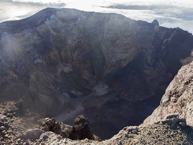 The crater of Mount Agung is seen from the top of the volcano. Fifty-four years after its last eruption, scientists believe it is on the brink of another. Photo by Alexandra Radu