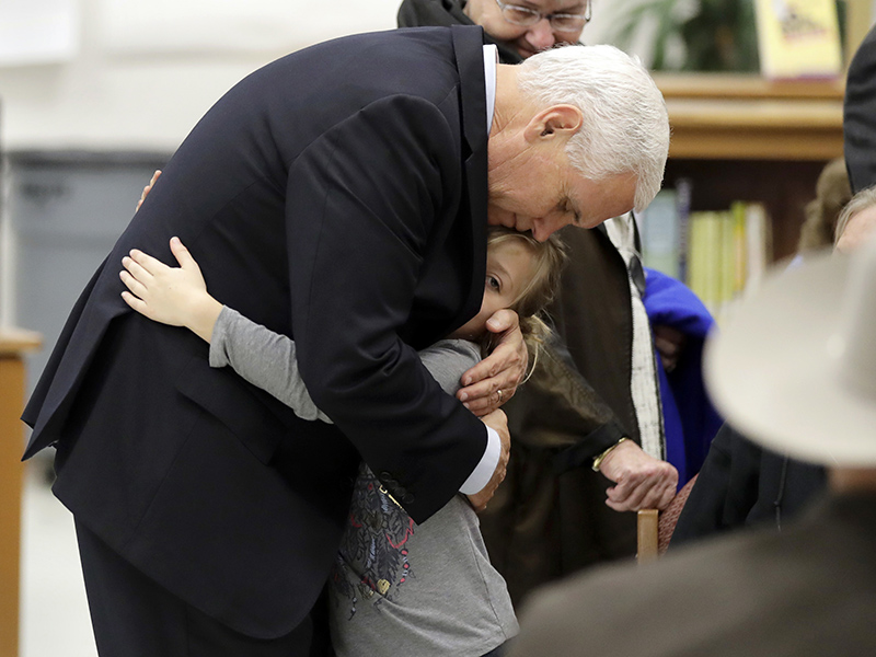Vice President Mike Pence hugs Evelyn Holcombe at Floresville High School during a stop Nov. 8, 2017, in Floresville, Texas. A man opened fire inside a church in Sutherland Springs on Sunday, killing and wounding many; Holcombe was in the church during the shooting but escaped. (AP Photo/Eric Gay)