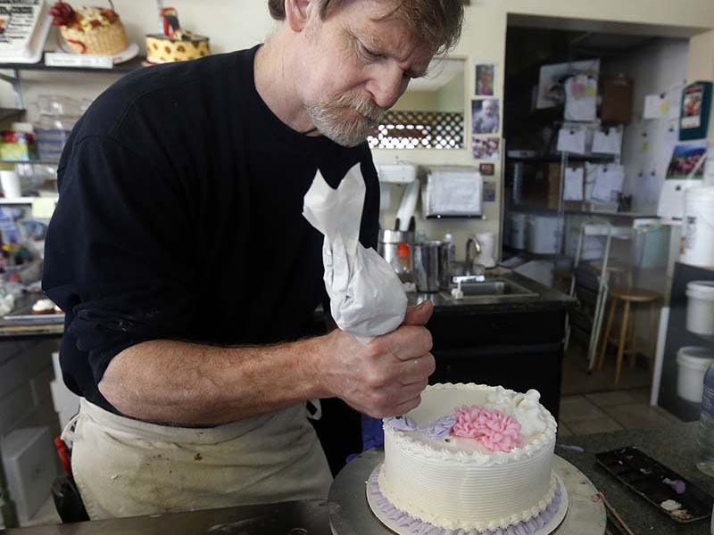 In this March 10, 2014, photo, Masterpiece Cakeshop owner Jack Phillips decorates a cake inside his store in Lakewood, Colo. Phillips is appealing a ruling against him in a legal complaint filed with the Colorado Civil Rights Commission by a gay couple he refused to make a wedding cake for, based on his religious beliefs. (AP Photo/Brennan Linsley)