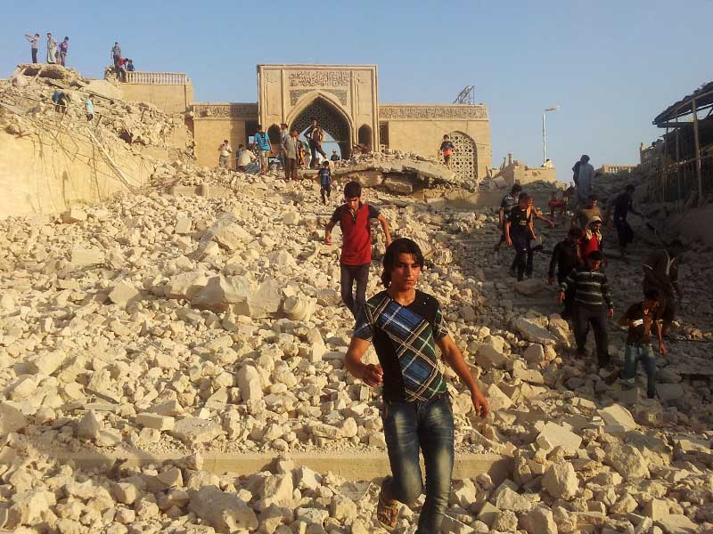 In this July 24, 2014, file photo, people walk on the rubble of the destroyed Mosque of the Prophet Younis, or Jonah, in Mosul, Iraq, 225 miles northwest of Baghdad. The revered Muslim shrine was destroyed by militants who overran the city in June 2014 and imposed their harsh interpretation of Islamic law. Fear, anger and sadness were palpable across Mosul on July 26, 2014, as rumors made their way across Iraq’s second-largest city. The militants who had taken over and purged it of some of its most cherished landmarks were eyeing their next target: al-Hadba minaret, an 842-year-old tower that leans, like Italy’s Tower of Pisa. The minaret is one of the country’s most famous structures and decorates the 10,000 dinar bill until today. (AP Photo, File)