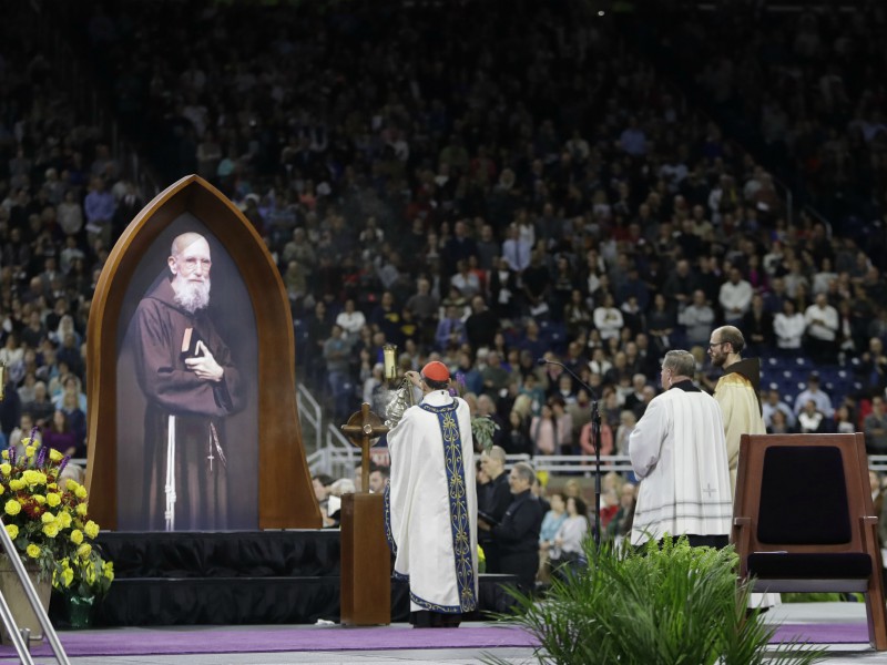Cardinal Angelo Amato blesses a portrait of Solanus Casey during a Mass of the Beatification ceremony Nov. 18, 2017, in Detroit. A priest who wasn't allowed to preach instead turned his ears and heart to the needy. Now, decades after Casey's death, he is on a path to sainthood, celebrated as an incredibly humble man who brought people to God. (AP Photo/Carlos Osorio)