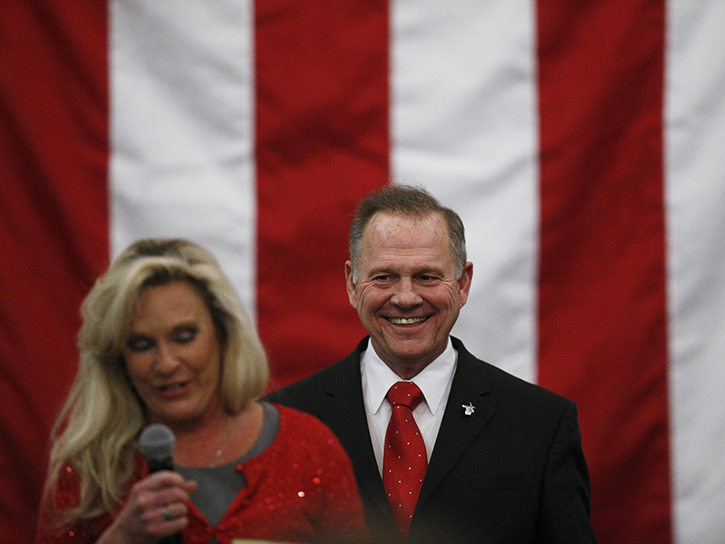 U.S. Senate candidate Roy Moore, right, listens as his wife, Kayla Moore, speaks at a campaign rally Dec. 11, 2017, in Midland City, Ala. (AP Photo/Brynn Anderson) (Caption amended by RNS)